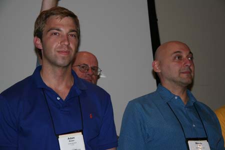 Adam Brown and Mauro Rech in the Hack Ack awards with Bill Hurley in the background as MC.